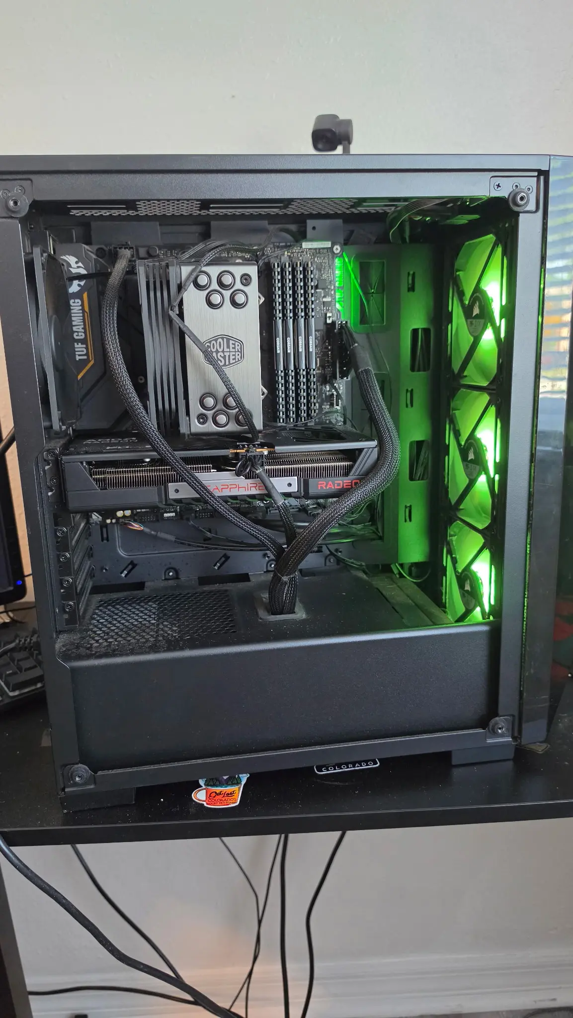 Side view of Tre Howell's custom gaming PC with green internal lighting